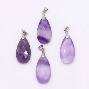 Detail of four teardrop-shaped faceted purple amethyst pendants with silver metal clasps
