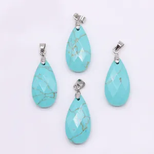 Macro shot of four teardrop-shaped turquoise pendants with faceted textures and silver bails