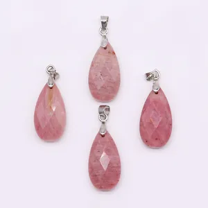 Detailed view of four faceted pink natural stone teardrop pendants with silver bails
