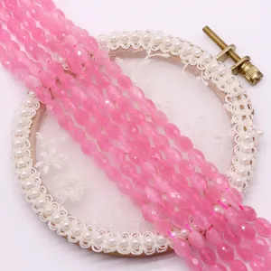 Faceted oval pink cat eye stone beads on embroidery hoop for DIY jewelry making