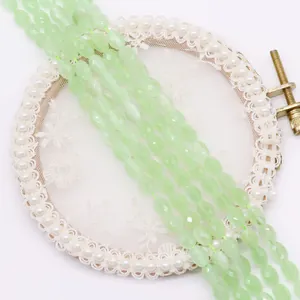 Detailed view of faceted oval light green stone beads for DIY jewelry making