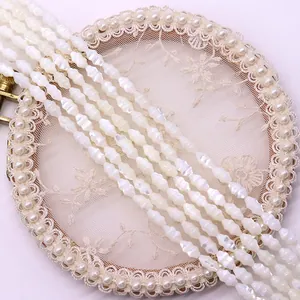 Macro detail of natural spindle-shaped shell beads with pearlescent luster for DIY jewelry