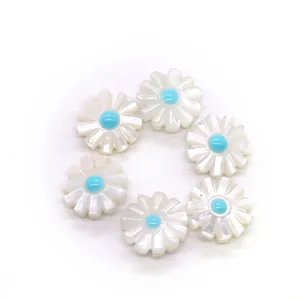Macro shot of 6 pieces daisy natural shell charms with blue center for jewelry DIY