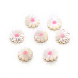 Detailed view of daisy-shaped natural shell beads with pink centers for DIY jewelry making
