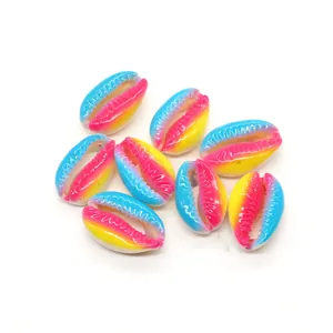 Macro detail of rainbow shell beads with gradient blue pink and yellow colors for DIY jewelry