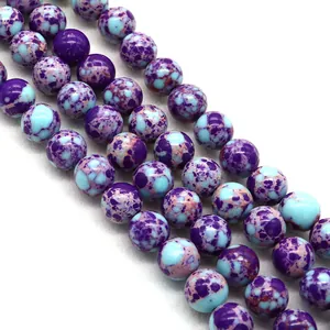 Macro shot of polished purple and blue Imperial Jasper round beads for DIY jewelry