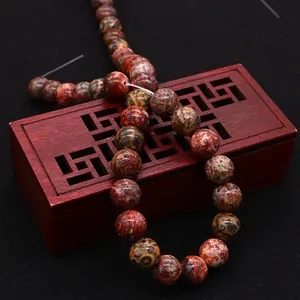 Red leopard skin natural stone beads on a vintage wooden jewelry box, DIY necklace beads