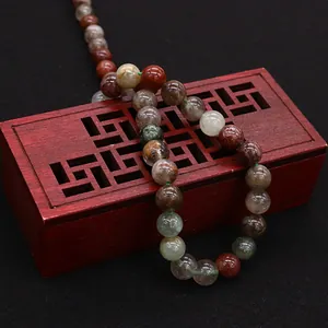Natural rutilated quartz and agate beads on vintage wooden box for jewelry making