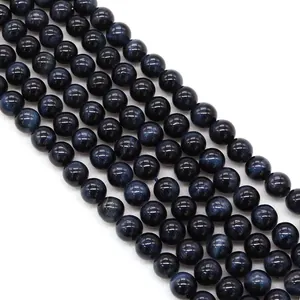 Macro shot of polished blue tiger eye stone beads with natural silk luster for DIY jewelry