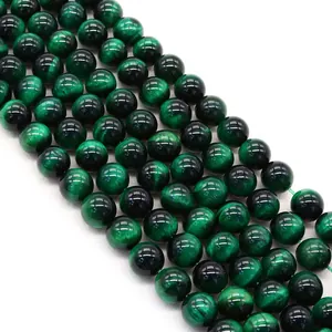 Macro detail of green tiger eye beads showing smooth polish and silk luster texture