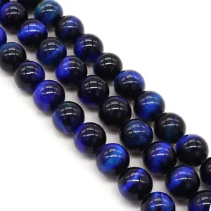 Macro detail of polished dark blue tiger eye round beads for DIY jewelry making