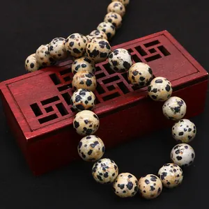 Natural spotted jasper round beads for DIY jewelry making on vintage wooden box