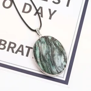 Oval turquoise pendant necklace with natural marble texture on white display card