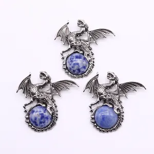 Detailed dragon pendants in silver finish with natural blue opal spheres