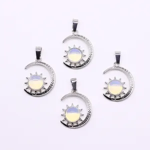 Detailed view of celestial sun and moon pendants with opal stone on white background