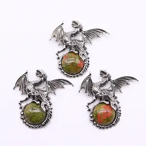 Detailed close-up of unakite stone sphere held by a silver-plated Viking dragon pendant