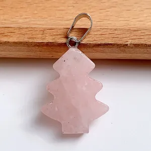 Macro detail of a rose quartz Christmas tree pendant with a silver metallic bail