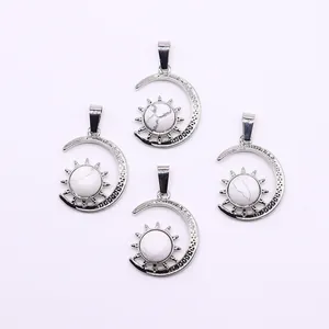 Detail view of four silver sun and moon pendants with white natural stone on white background
