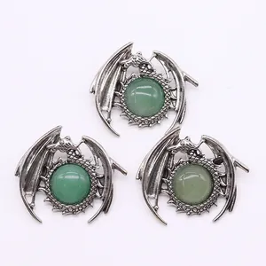 Macro detail of vintage silver dragon pendants with polished green malachite stones