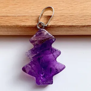 Macro shot of natural purple amethyst Christmas tree pendant with silver metal bail clasp