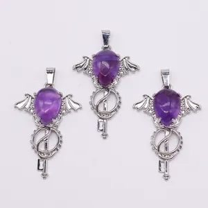 Detailed view of amethyst style angel wing pendants with silver key design elements