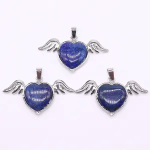 Macro shot of three heart-shaped lapis lazuli pendants with silver angel wings detail