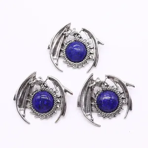 Macro shot of silver dragon-wrapped lapis lazuli pendants with vintage finish