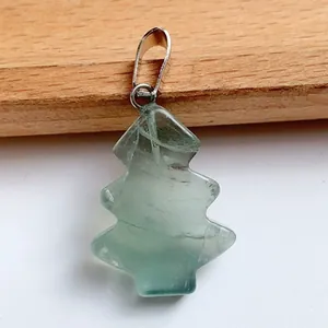 Macro view of Christmas tree shaped green fluorite gemstone pendant with silver bail