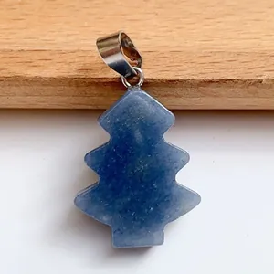 Macro detail of Christmas tree shaped blue lapis lazuli pendant with silver clasp link