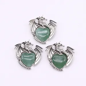 Detailed view of silver dragon wrapping around heart-shaped green aventurine stone pendants