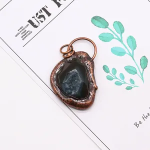 Close-up of vintage bronze irregular stone pendant with deep blue crystalline texture