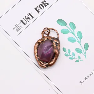 Detailed macro of a purple faceted agate stone pendant with vintage bronze finish