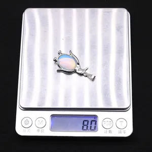 Macro weergave van het wegen van de blauwe ovale opalen hanger van 8,0 gram zwaar