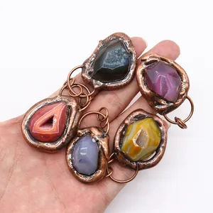 Set of five irregular natural agate and druzy stone pendants with copper metal frames