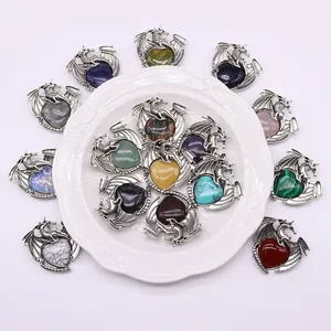 Assorted heart-shaped natural stone pendants wrapped in silver dragon-shaped metal wings