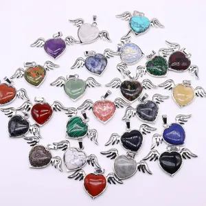 Collection of heart shaped gemstone pendants with silver angel wings on white background