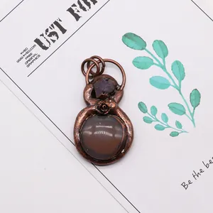 Detailed view of gourd-shaped dragon vein agate pendant with rose motif and purple crystal