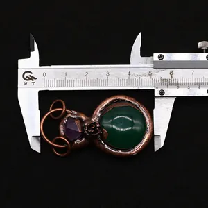 Detailed measurement showing 54mm width of vintage stone pendant with floral metalwork