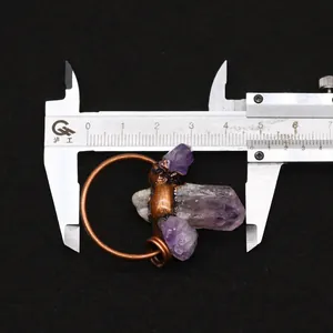 Detailed macro view of a 4.5cm natural amethyst cluster pendant wrapped in copper