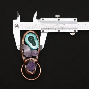 Detail view of natural stone pendant showing length and width using a digital caliper