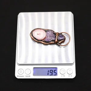 Detailed shot of handmade natural agate pendant on electronic scale weighing 19.5g