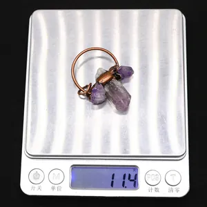 Macro shot of handmade amethyst stone pendant weighing 11.4g on a digital scale
