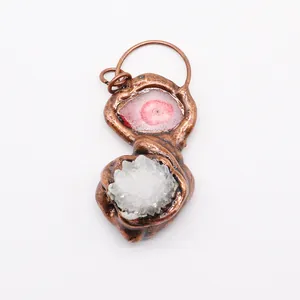 Detailed view of handmade bronze pendant with agate slice and white druzy crystal