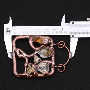 Macro detail of antique bronze quartz pendant showing size measurement of 6.5cm