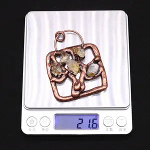Detailed view of handmade antique copper square pendant with yellow crystals weighing 21.6g