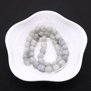 Natural labradorite irregular loose beads for DIY jewelry making on white floral plate