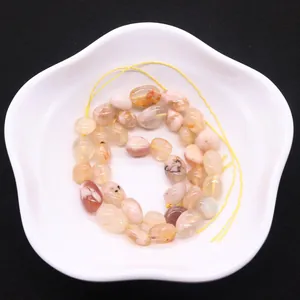 Natural cherry blossom agate irregular beads for DIY jewelry making on white dish