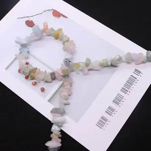 Irregular natural stone beads in pastel colors for DIY jewelry making on black background