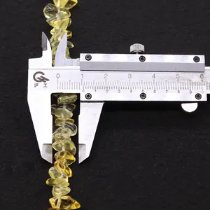 Macro shot of natural citrine irregular beads with 8-9mm measurement on calipers