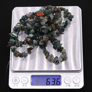 Detailed close-up of natural irregular Indian agate stone beads on a precise digital scale